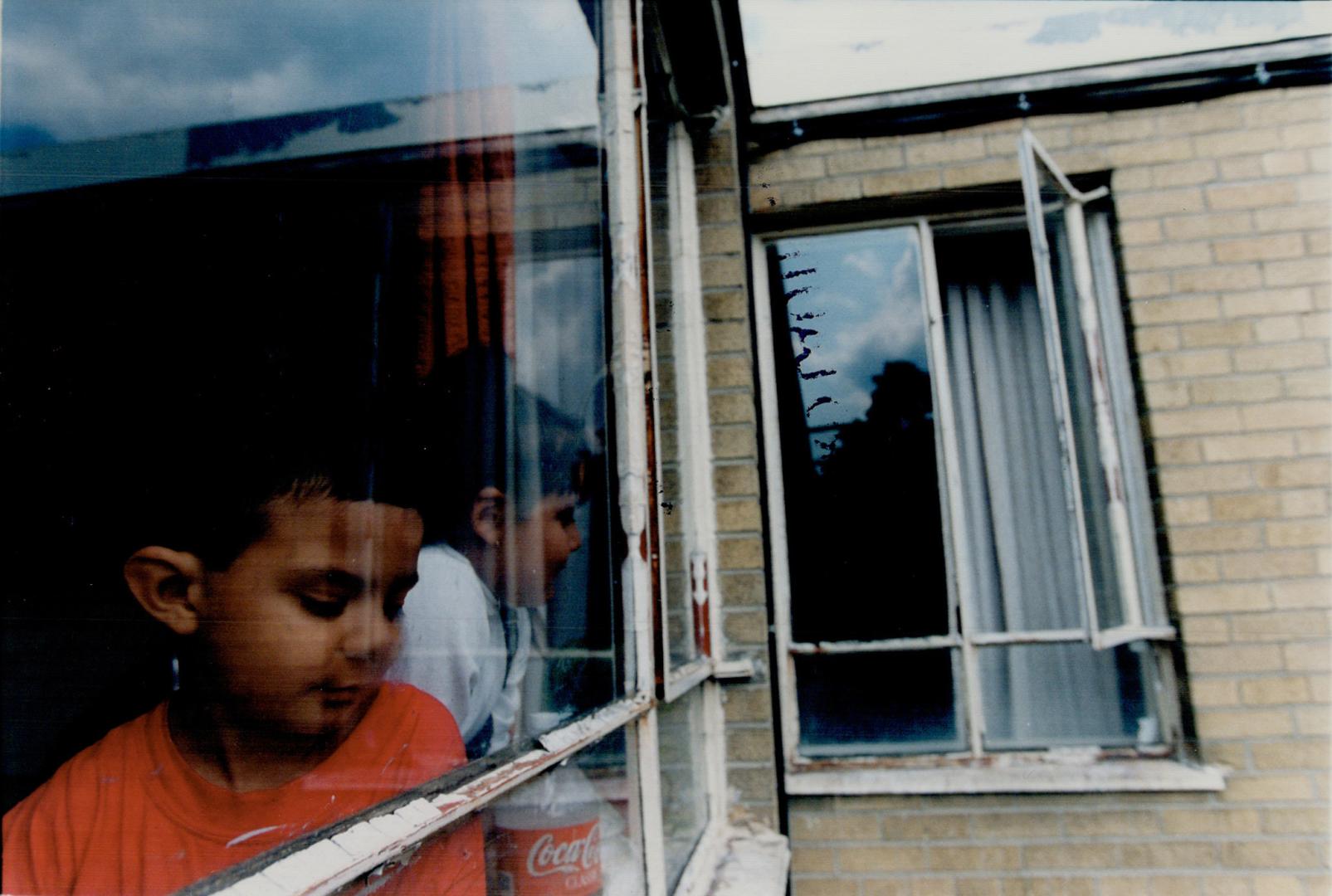 Accident Scene : Cousins Mark Carneiro, 5, in the foreground, and Paola Ulloa, 7, have a good view of the open fourth floor window from which 3-year-old Nicholas Wood plunged on Monday