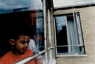 Accident Scene : Cousins Mark Carneiro, 5, in the foreground, and Paola Ulloa, 7, have a good view of the open fourth floor window from which 3-year-old Nicholas Wood plunged on Monday