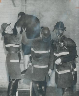 Jean Lemmon, 60, is helped to safety from third floor