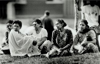 Evacuated From Building: Women evacuated from a Mississauga apartment building wait for word that they can return to the high-rise after an apartment was gutted by an explosion and fire early today