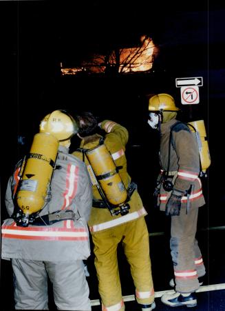 Support Team: Firefighters outside the Holy Blossom Religious School monitor the safety of colleagues inside the blazing building today