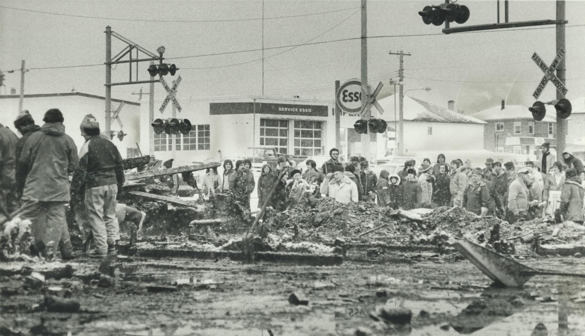 Townspeople gather to watch anxiously as the rubble of a fire-levelled nightclub is sifted in a search for bodies of victims, many of them relatives of the onlookers