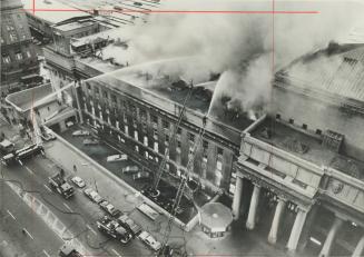 Dense Smoke billows out of Postal Terminal A at Bay and Front Sts