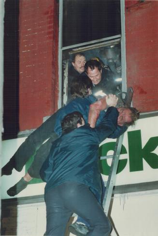 Firefighters rescue a man from a spectacular blaze at Queen and Parliament Sts