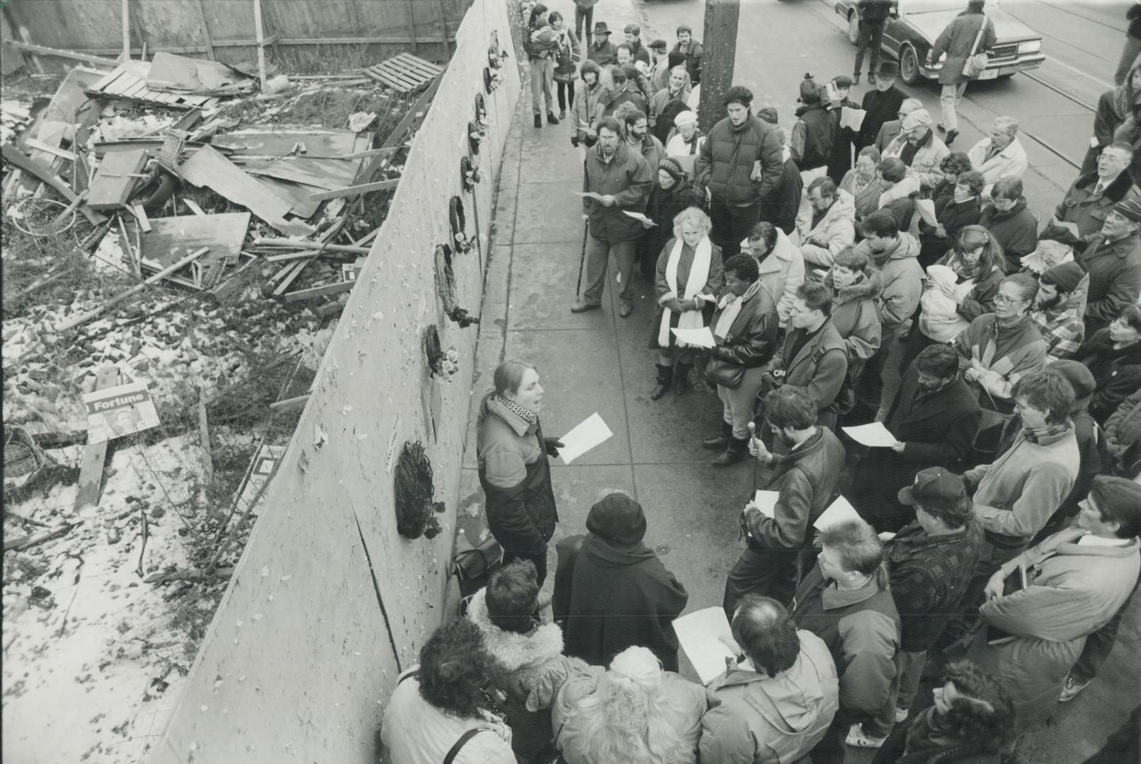 Paying Respects: About 100 people join a memorial yesterday at the site of the Rupert Hotel, where arson killed 10 residents in 1989