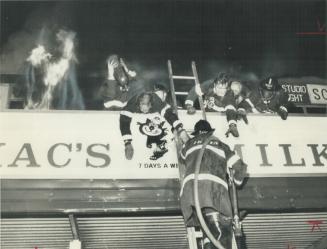 Firemen scramble on roof of burning North York shopping plaza early this morning