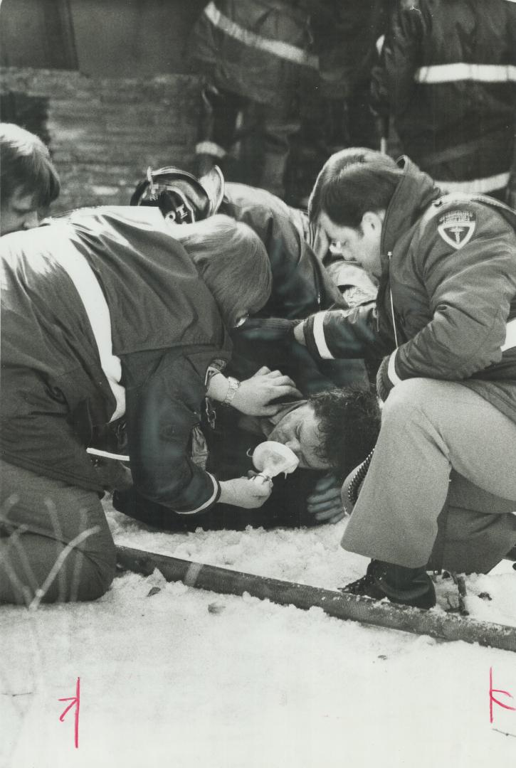 Fireman gets helping hand. Jimmy Challis, one of four Toronto firemen injured today fighting a fire in seven frame houses on Moutray Ave. in the Colle(...)