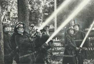 Crews of firemen pour water on to burning Ontario St