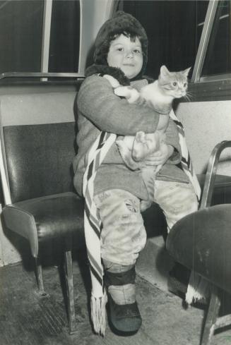 Hero cat. Five-year-old Sasha Radenovic hugs Puss, whose frantic meows roused her family early today when fire broke out in their home