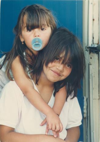 Daring act: Carla Pacheco, 9, with niece Paula, 3, on her back, was an inspiration for everybody in the way she saved her nephew Victor from a fire, says a fire official