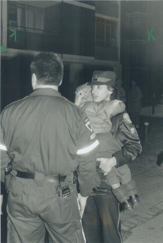 Child rescued from fire. A little boy is carried to safety last night and 100 were evacuated after a candle started a $100,000 fire in a eight-storey Parkdale apartment building