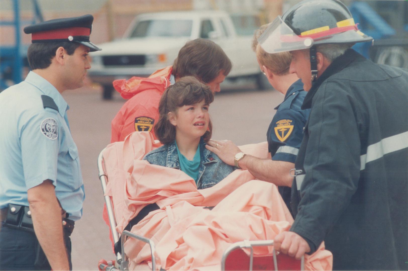 An injured Grade 6 student is taken to hospital on a stretcher after an escalator at the CN Tower went out of control yesterday. Students were bunchin(...)