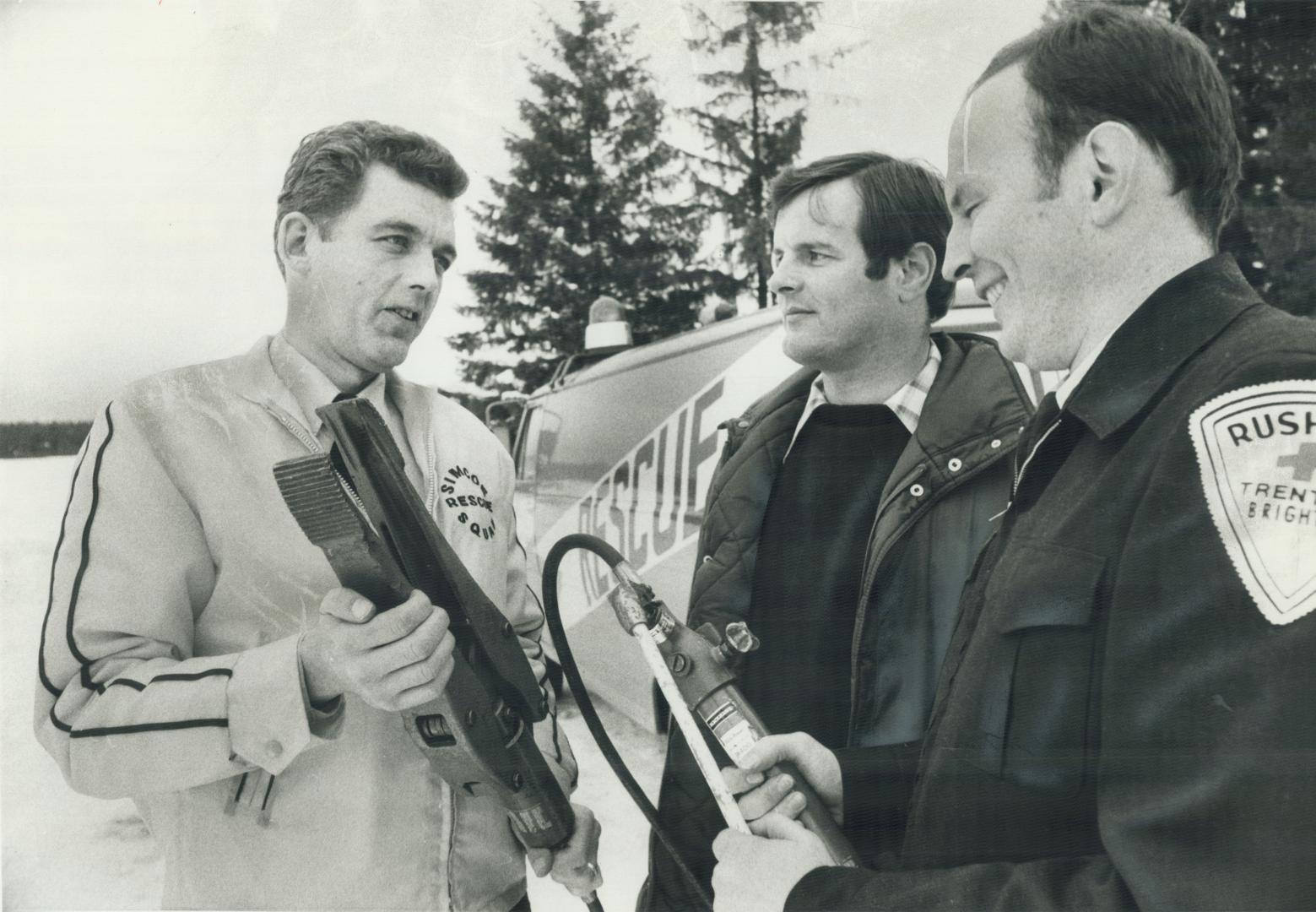 Discussing rescue 'jaws' are, left to right, Gary Joice, Dr. Duncan Paterson and Rick Percival