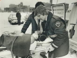 Ambulance men carry injured boy from helicopter to Sunnybrook Medical Centre