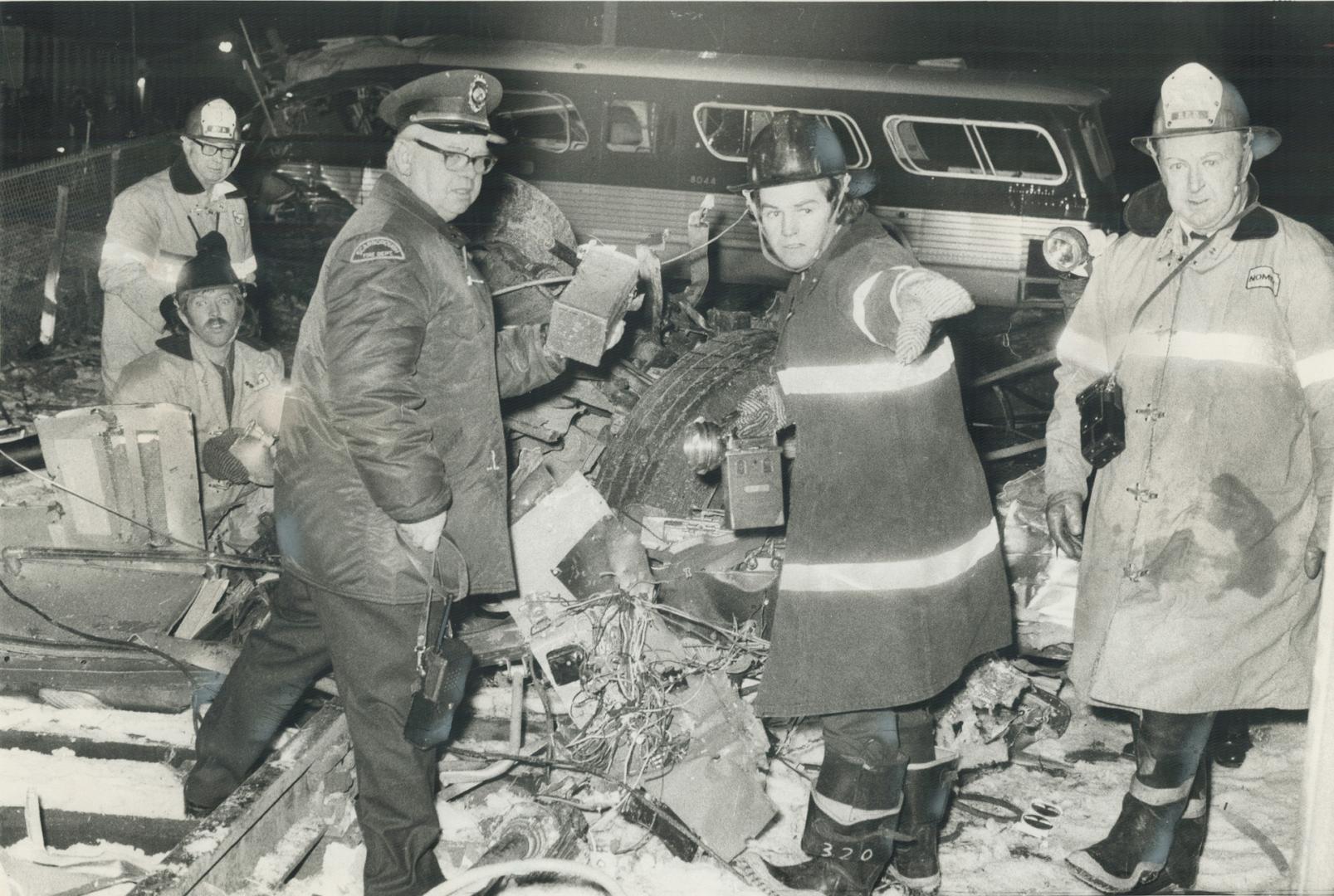 Firemen search through debris at Scarborough bus-train crash