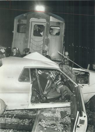 Fatal crash. Tangled wreckage marks the spot where a 30-year-old Scarborough man was killed when his car was hit yesterday by a CN Dayliner at a level(...)