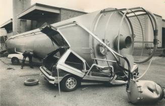 Train hits silo, silo crushes car