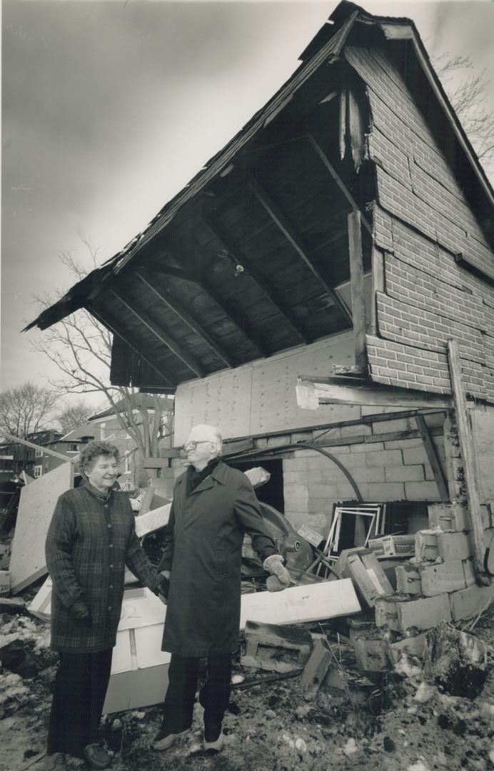 Close call: Joyce and Dr. John McClintock's garage was smashed when wheels flew of a box car. Cars tumbled down the rail right of way just a few metres from their home