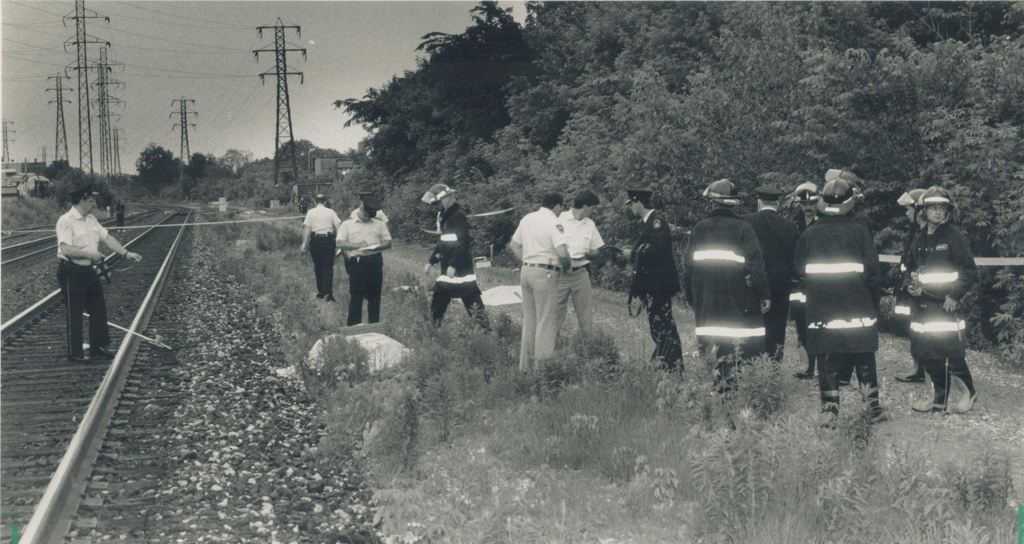 Metro police and CN Rail officials search the tracks near Dupont and Huron Sts