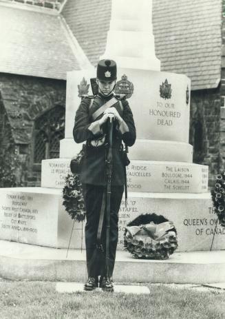 A rifleman stands on guard at the cenotaph on Bloor St