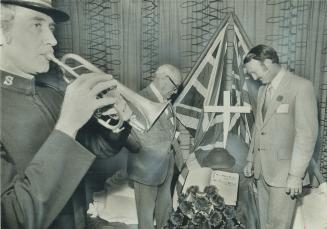 Remembering the dead, Conn Smythe (centre) and Bernie Dunn (right) pause for a bugle call last night at the annual reunion of the 30th Light Anti Airc(...)