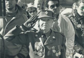 Proud memories: Jessie Hawley, 86, a master chef for World War I troops adorned with the family medals, salutes her fallen comrades at the Remembrance Day service at old city hall yesterday