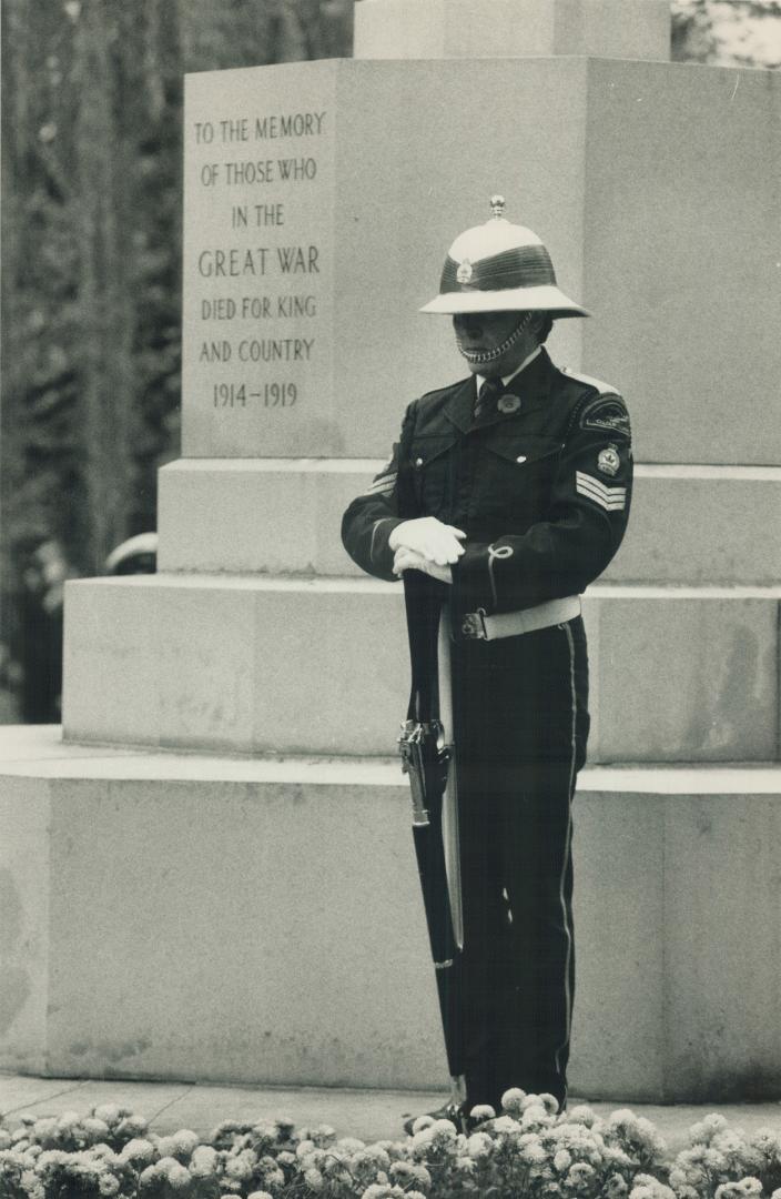 A Royal Canadian Legion member stands at Reverse Arms before the Cenotaph at today's Remembrance Day service in Prospect Cemetary