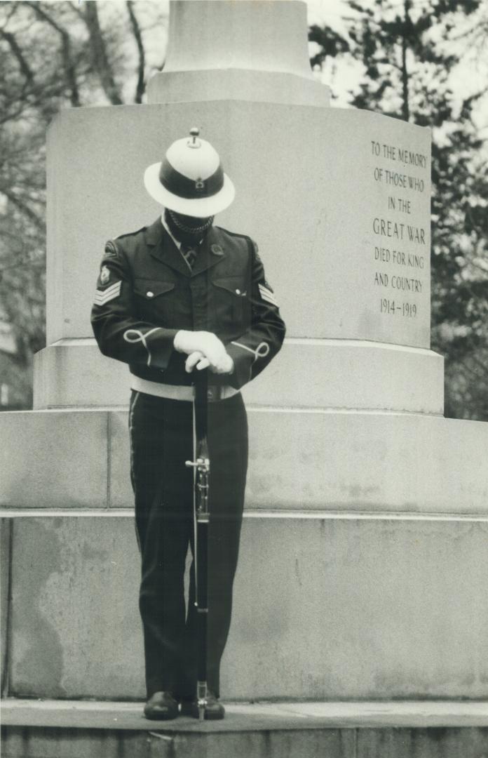 A member of the Color Guard of the Earlscourt branch of the Royal Canadian Legion stands with reversed arms during the sunrise service at Prospect Cemetery today