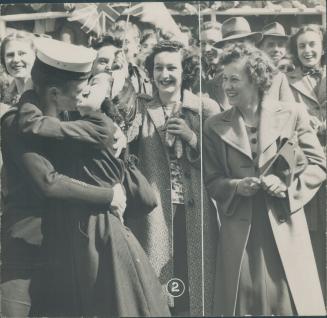 A sailor gets a resounding victory kiss