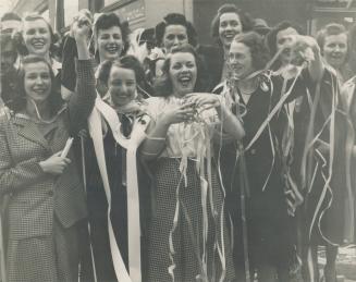 Decked with yards of ticker tape, these girls were among the thousands who milled about the streets celebrating victory day. But there were sober mome(...)