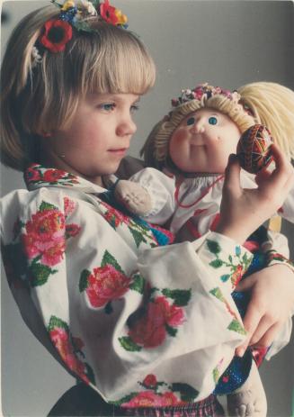 Ukrainian Easter. Melinda Semkiw, 7, of Mississauga, examines the intricate design on a hand-painted Ukrainian Easter egg. Melinda is also grabed in t(...)