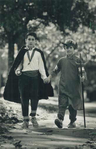 Streetproofed kids: Matt Yanchyshyn, 10, and his brother Ben, 8, are decked out for safe trick-or-treating, with a flashlight and reflective tape on their costumes