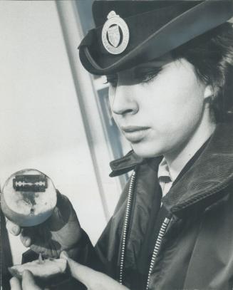 Booby-trapped apple with razor blade concealed inside is examined by policewoman Carol MacKay last night