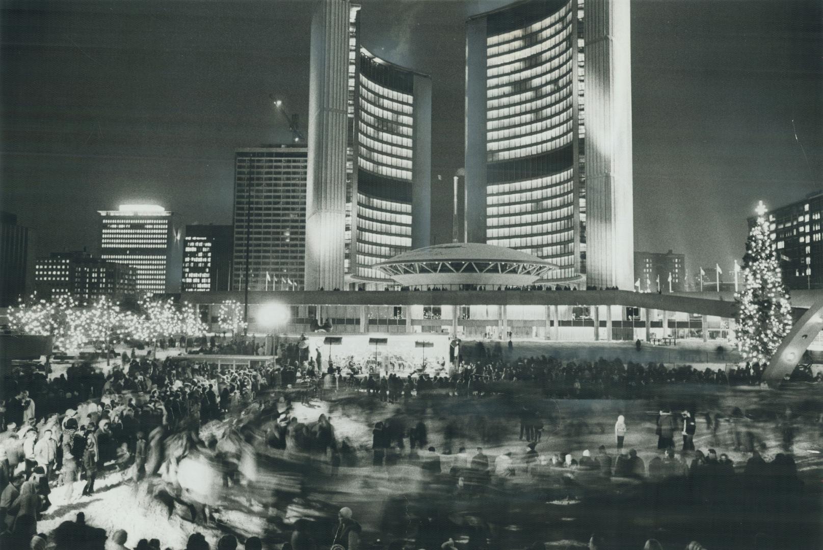 Crowds of happy revellers gather in Nathan Phillips Square last night, skating on the rink and dancing around the brightly lit square to welcome in the New Year