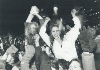 Whooping it up: Tammi Dexter, left, and Paggy Palombo throw up their arms in joy and welcome the New Year as the city hall clock strikes midnight