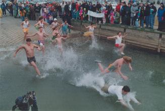 The Popsickos charge into Lake Ontario yesterday at Bluffers Park