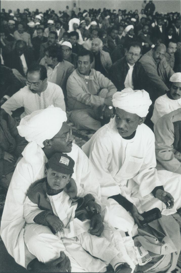 You're never too young. Mohamed Hussein Joins his father Hussein, left, and Ahmed Mohamed, right, as 3,000 Metro Muslims gather at the Better Living C(...)