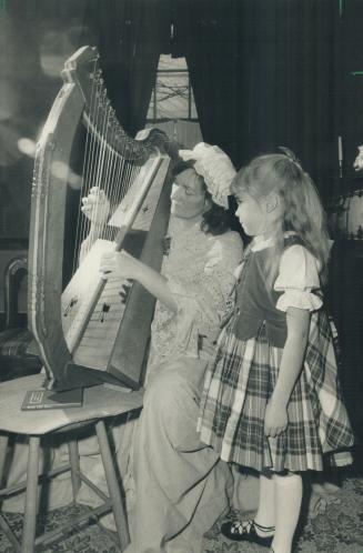 Happy birthday, Robbie Burns. Colleen Rintamaki, 7, enjoys the sounds of traditional Scottish music played by Gillian Federico on the clarsach, the Ce(...)