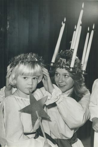 How Swede it is. Louise Bridgeman, 18, the Scandinavian-Canadian Club's Queen of Light helps Leea Leivo, 5, with her tinsel halo. The Scandinavian pre(...)