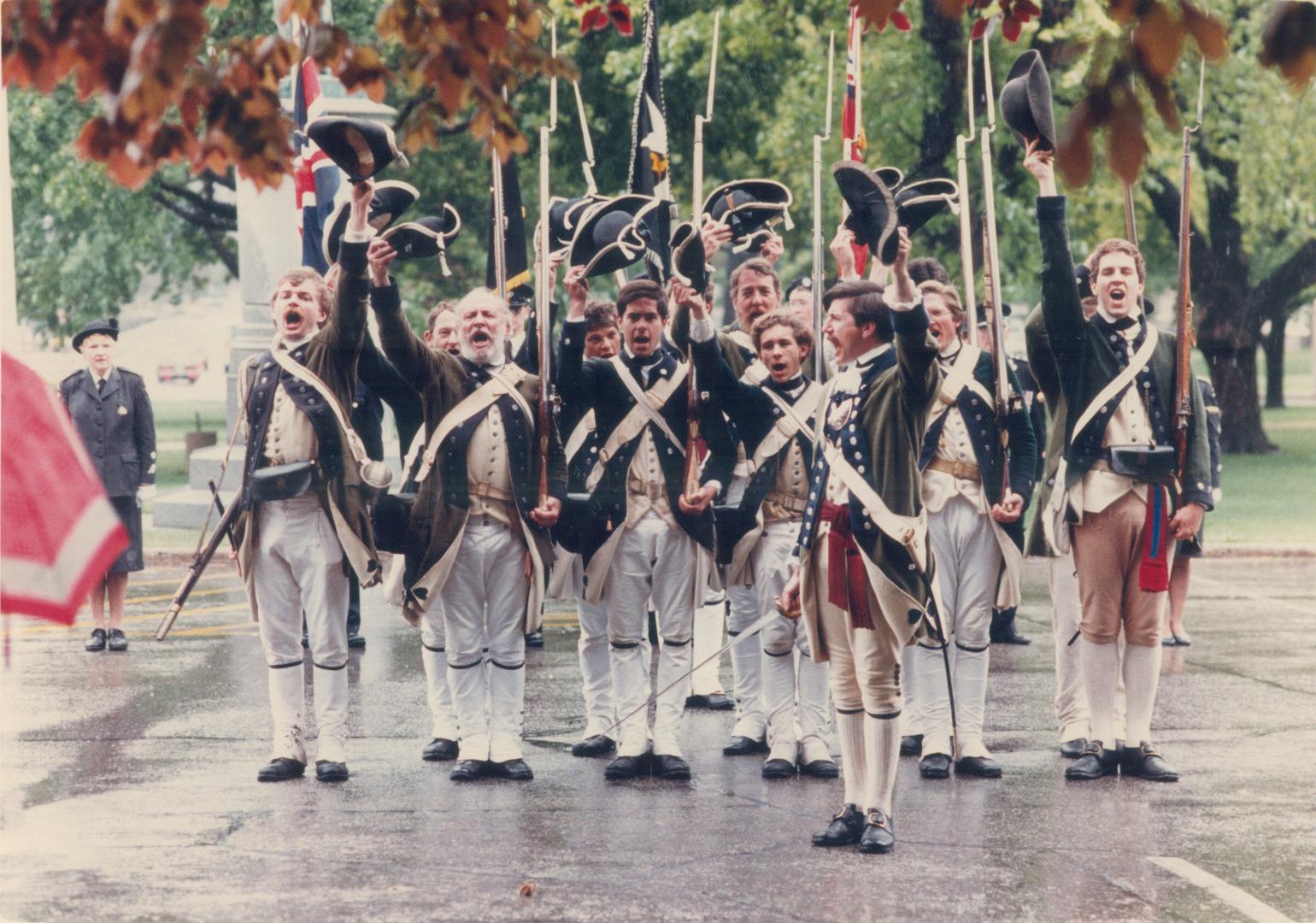 The King's Royal Regiment salutes the Queen in a soggy ceremony at Nathan Phillips Square