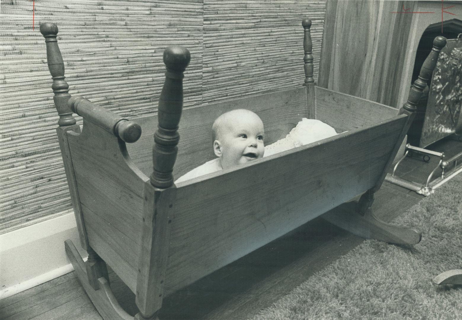 Rory Gilfillan enjoys a nap in handsome antique pine rocker