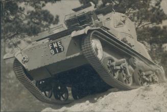 One of Canada's fighting tanks, six tons of concentrated destructive power, tops a rise at Camp Borden as recruits put it through actual war paces. Th(...)