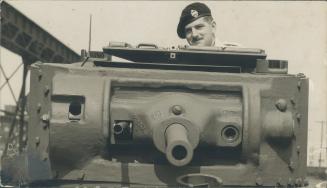 Stirton, a Dunkirk survivor of the Royal Tank Corps, sits in the power-driven Canada's first army tank as it rolls from the assembly line of the C.P.R(...)