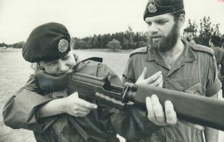 Master Cpl. Jim Breakey coaches Pte. Michele Ball, 19, in use of her rifle. Classes run from July 2 to Aug. 10