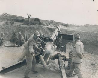 Big gun ejects shells as Chinese Nationalist troops keep up desperate fight against Communist attackers who today are locked in an all-out fight north(...)