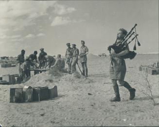 Bully beef and biscuits may constitute the entire menu for these men of a Highland division, Above, but they still relish their pipe music