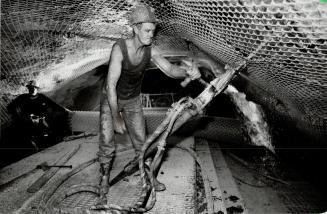 Below left, a worker drills rock-bolt holes in the intake tunnel, which will curve 1,000 metres under Lake Ontario