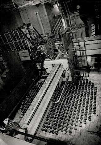 Guys are standing on machine that loads fuel bundles into the 480 tubes in reactor core