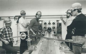 John Langford demonstrates the proper use of the shield plug installation tool following end fitting stub removal during training