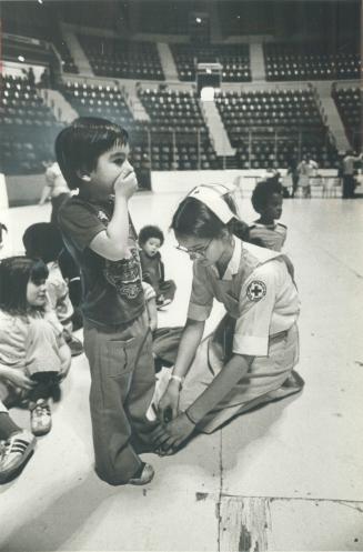 Red Cross volunteer Joy Nantz plays with evacuated children